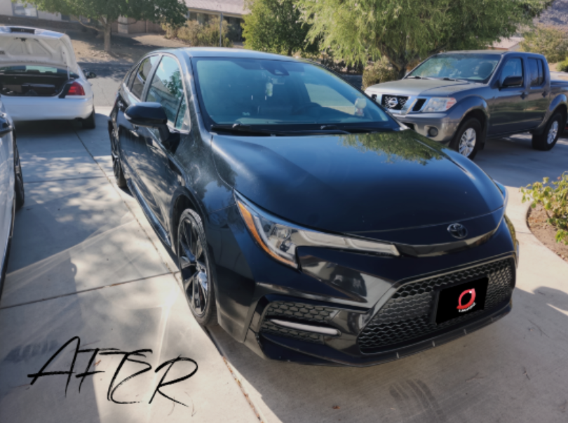 After detail - black sedan glossy finish with clean wheels and glass