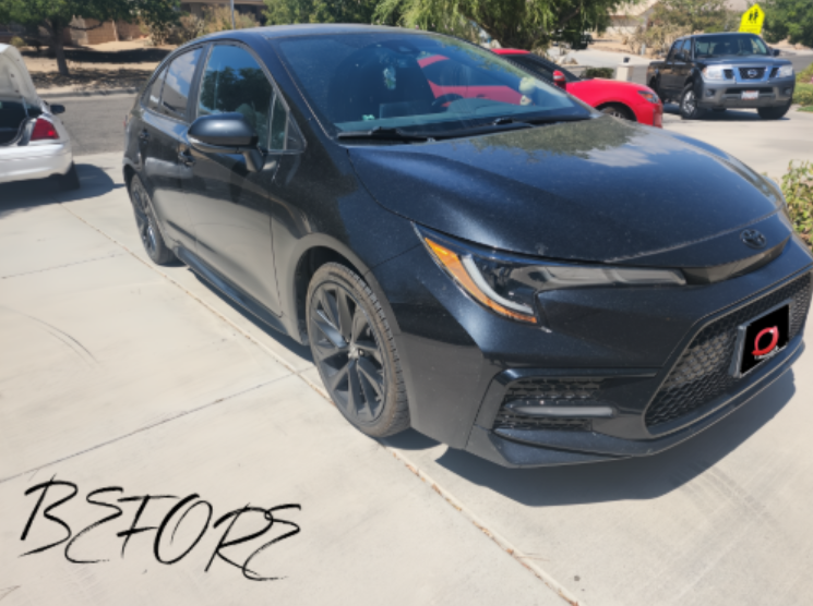 Before detail - black sedan with road dust on paint and wheels
